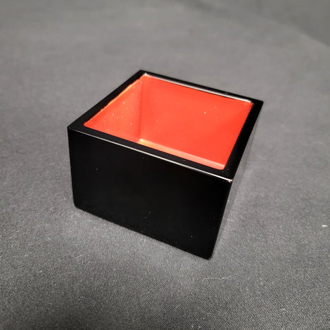 Fukui black and vermilion masu sake cup, three-quarter view