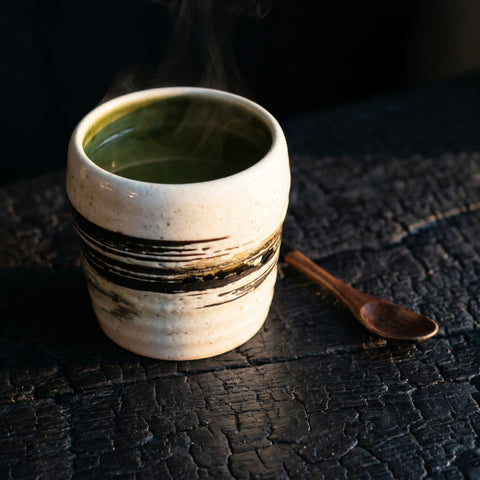 White rustic cup with hand-painted brown and green brush stroke