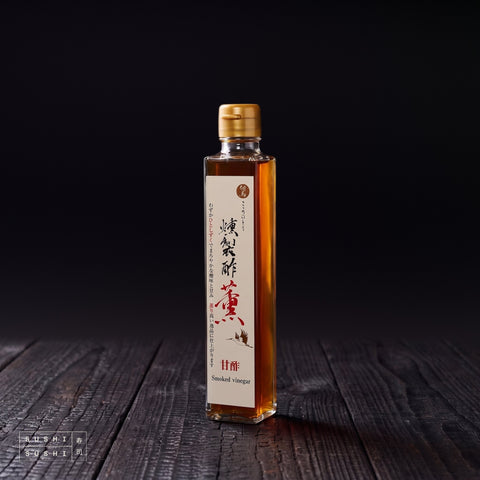Tajima, Sakura Smoked Vinegar, 200ml, bottle on a charred shou sugi ban wooden surface against a black background