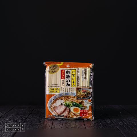 Toa, Dried Ramen Noodles, 720g, pack on a charred shou sugi ban wooden surface against a black background
