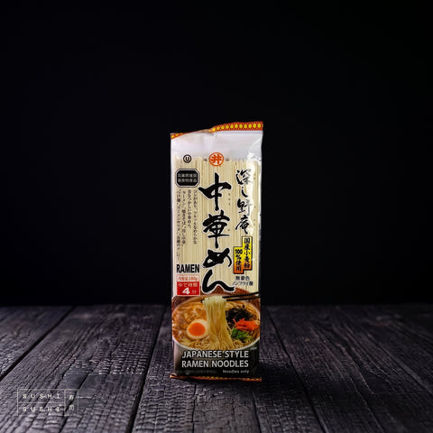 Toa, Japanese Wheat Dried Ramen Noodles, 180g, pack on a charred shou sugi ban wooden surface against a black background