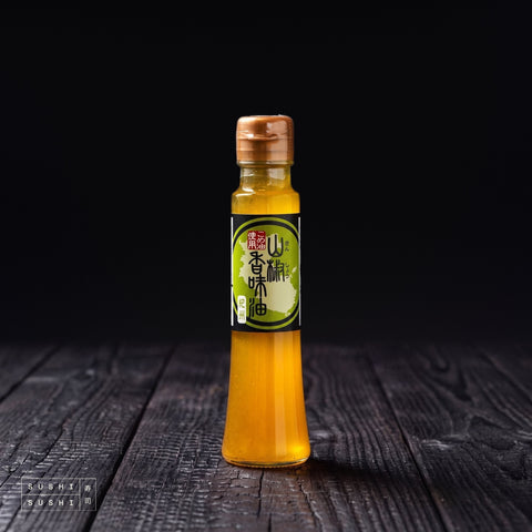 Tsuno, Sansho Oil, 150ml, bottle on a charred shou sugi ban wooden surface against a black background