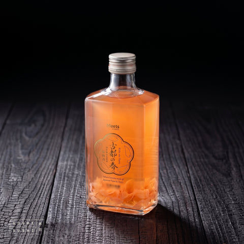 Yamato Japanese Cherry Blossom Plum Wine (Sakura Umeshu) 500ml, bottle on a charred shou sugi ban wooden surface against a black background