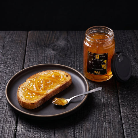 Yuzu Zest Marmalade, 160g, spread on toast beside the open jar